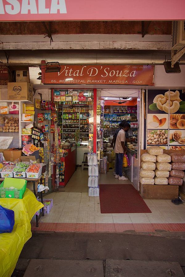 A vibrant market scene featuring a shop entrance in Mapusa, Goa.