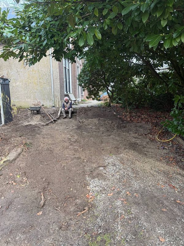 Photo of two men building wooden stairs outdoors on a sunny day.