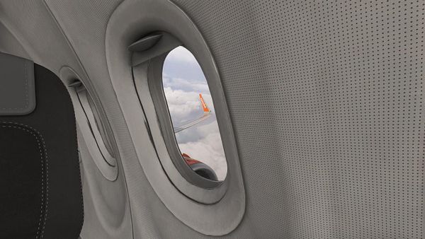 A nighttime aerial view of Lisbon Airport captured during Storm Ingrid, showing runway lighting and surrounding city lights beneath a stormy sky.