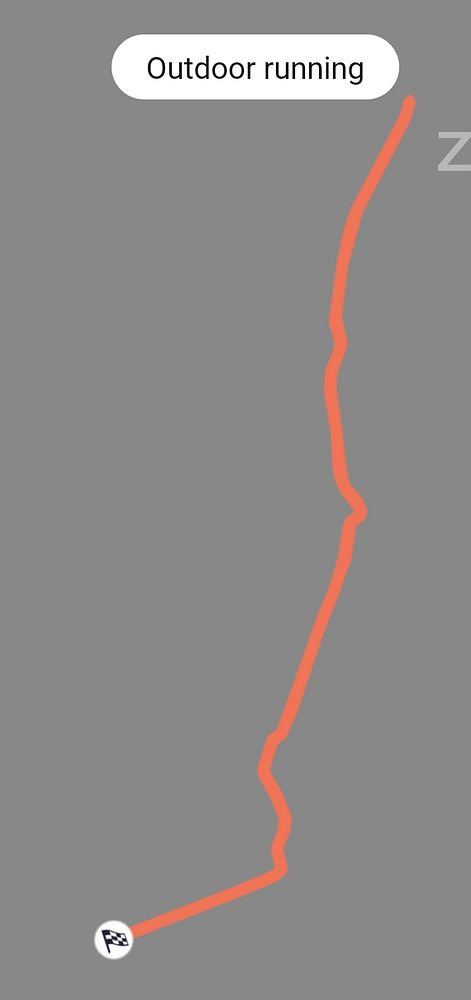 Photo of a person holding a smartphone displaying a running app tracking a 5.5km run.