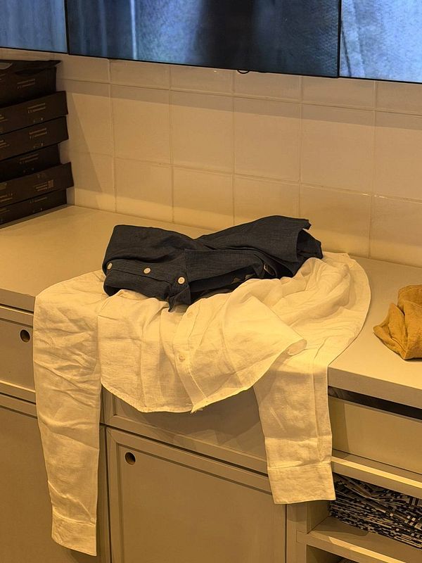 A fashion lookbook layout featuring models in linen clothing, with various outfit shots and descriptions.