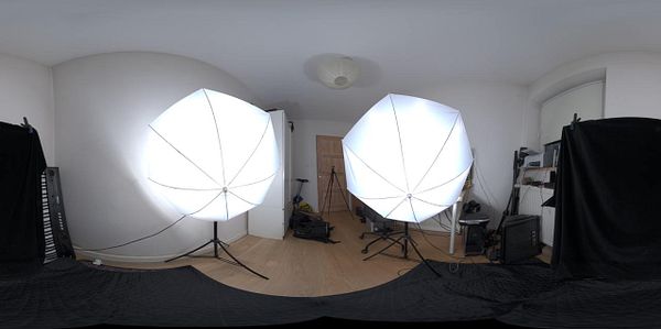 The image depicts a well-lit studio setup featuring two large softbox lights in a room.