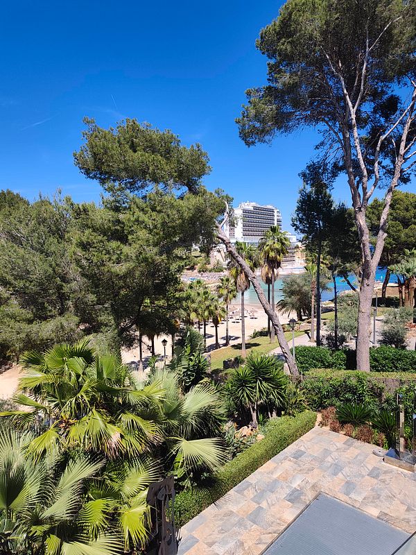 Photograph of a luxurious Mediterranean villa with a swimming pool and outdoor seating area.