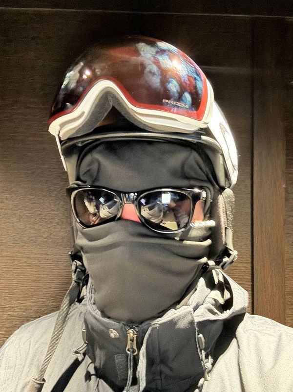 A person is dressed in ski gear, ready for skiing.