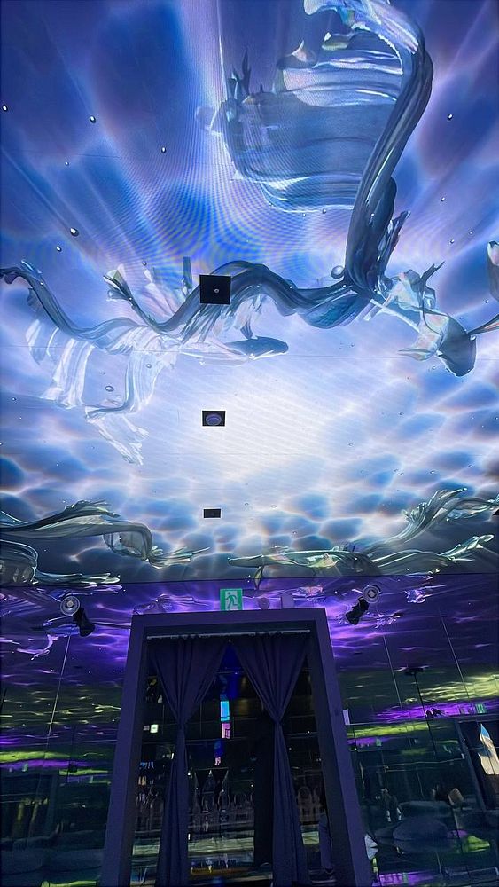 The image captures a vibrant, artistic ceiling display in a modern space.