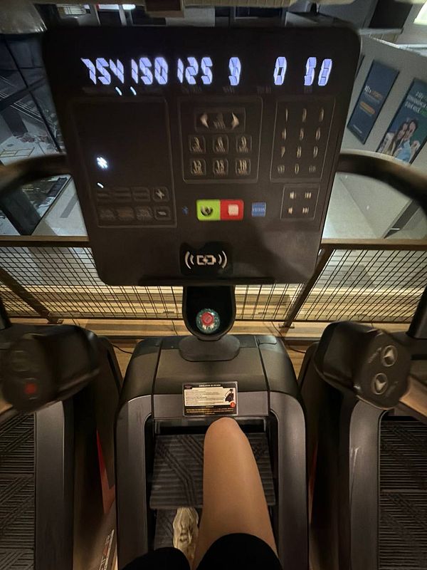 A man lifting a heavy barbell in a gym.