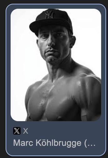 A black and white portrait of a muscular man wearing a cap.