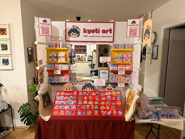 A vibrant art booth display featuring various handmade products.
