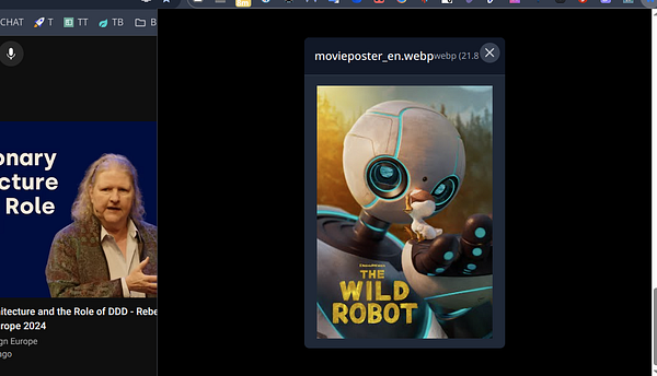 A movie poster for 'The Wild Robot' featuring a friendly robot and a small bird.
