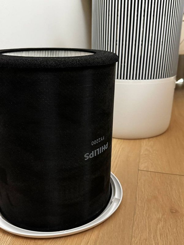 Close-up of a dirty air filter showing accumulated dust and debris after one month of use.