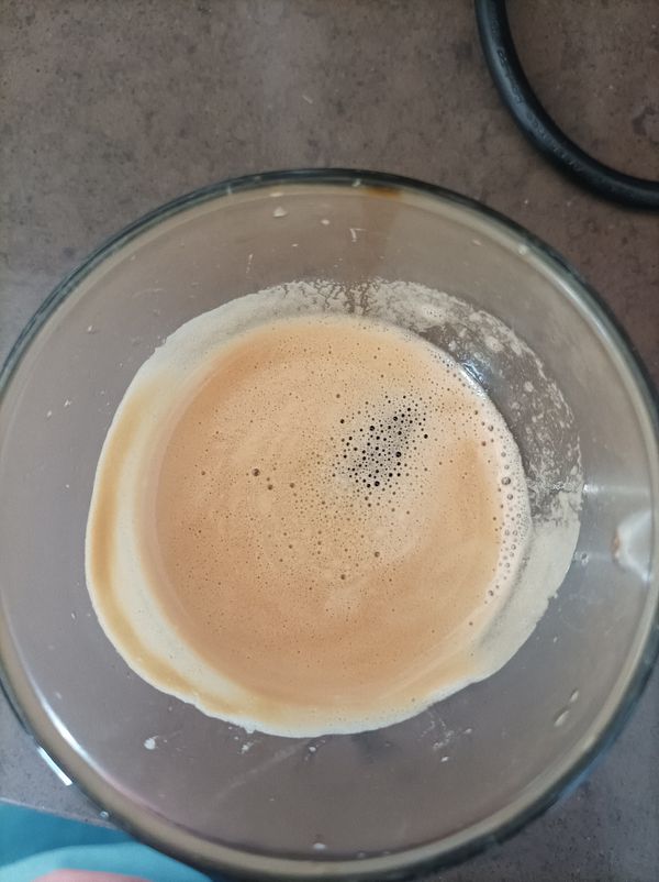 A close-up view of a glass containing freshly brewed espresso.