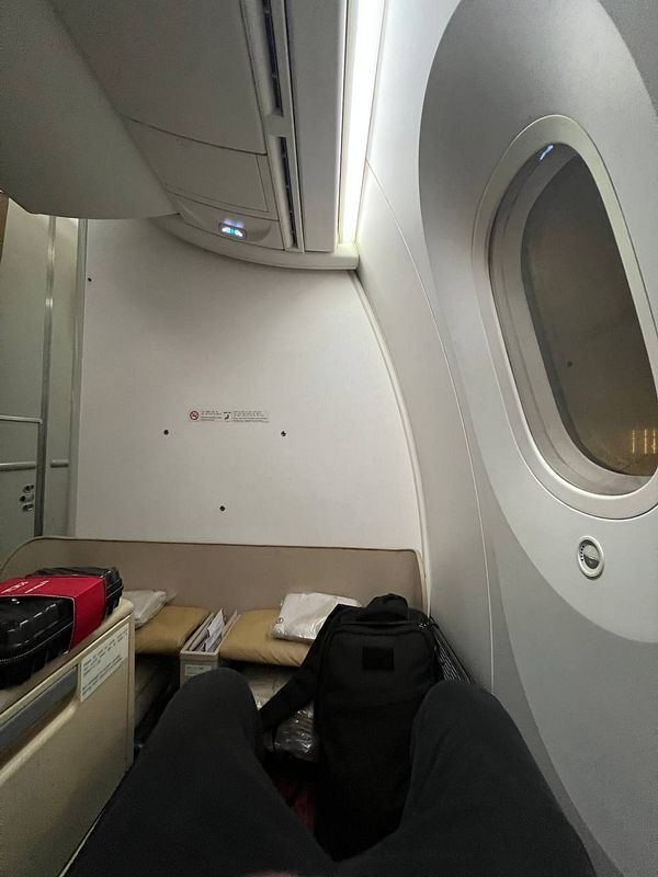 The image captures the interior of an airplane cabin, specifically a business or first-class seating area.