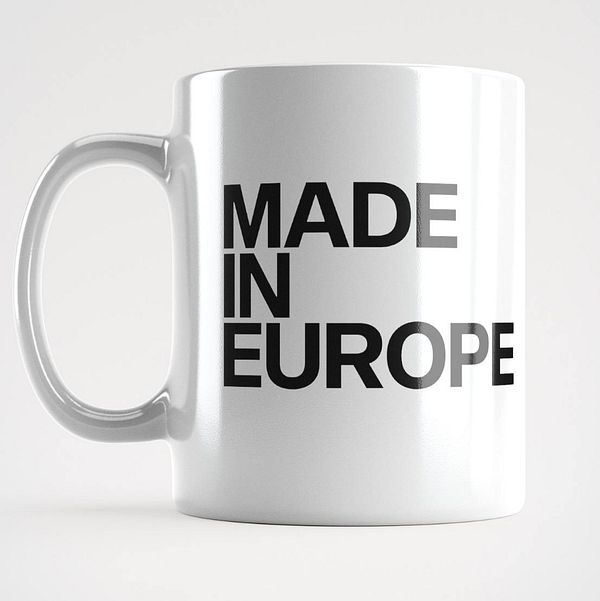 A white ceramic mug featuring bold black text that reads 'MADE IN EUROPE'.