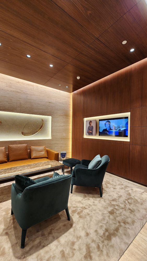 A luxurious interior of a Rolex boutique featuring elegant seating and modern decor.