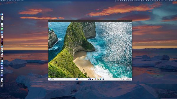 A Windows virtual machine displaying a scenic beach view is open on a macOS desktop.