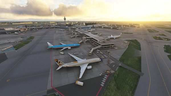 A detailed aerial view of an airport with multiple aircraft and terminal buildings during sunset.
