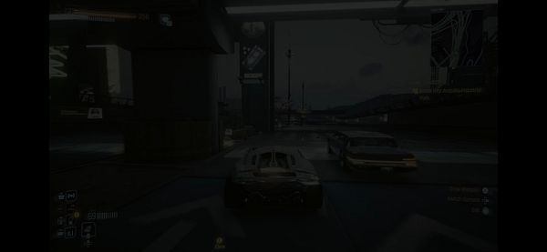 A gameplay screenshot from a racing game featuring a car in a dimly lit urban environment.