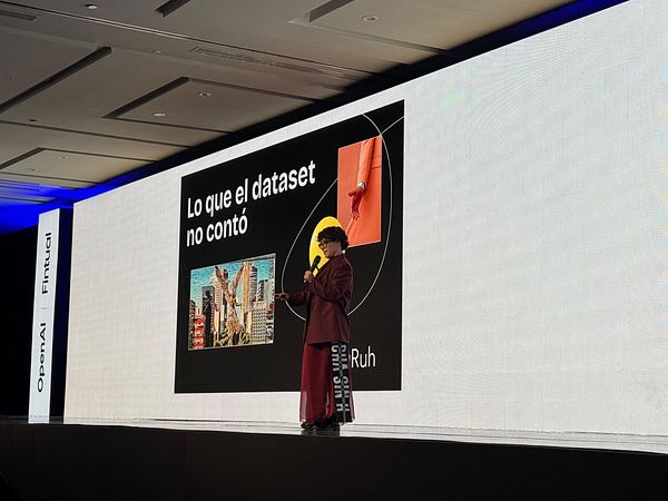 A speaker presents at the AI Summit, discussing insights related to datasets.