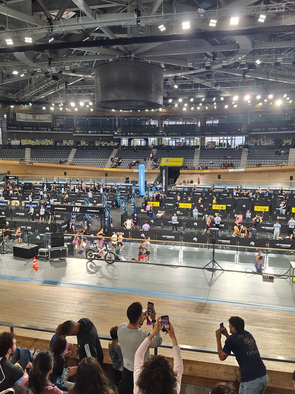 A group of people gathered at the StrongRace event with visible banners and a lively crowd.