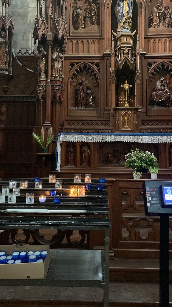A group of people attending a church service inside a traditional church interior.