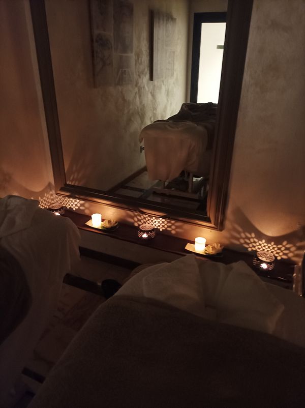 A serene spa room set up for a massage experience.