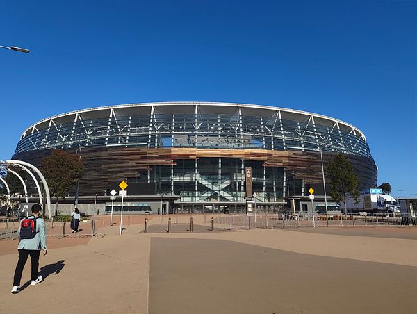A person approaches Burswood Stadium on a clear day.