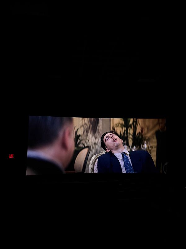 A street art mural featuring a colorful depiction of a woman with sunflowers in a vibrant urban setting.