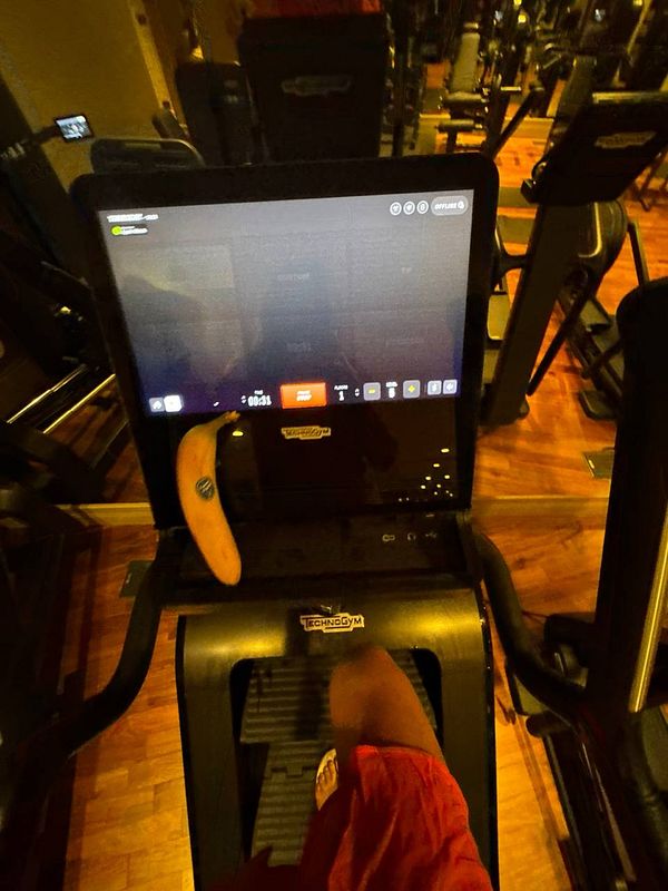 A person is using a treadmill in a gym setting.