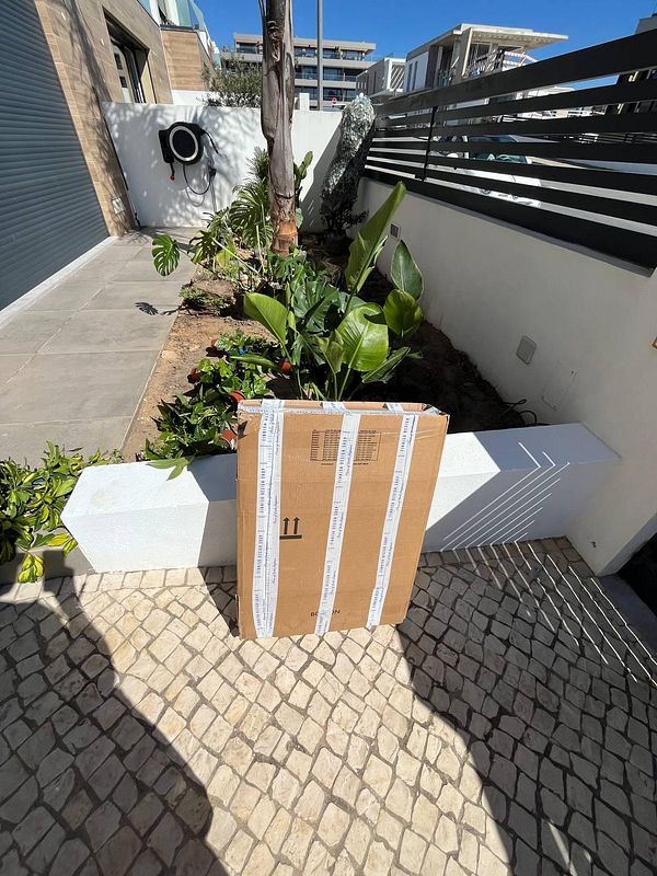 A broken glass mirror with jagged cracks lies on a rail track with scattered glass shards around it.