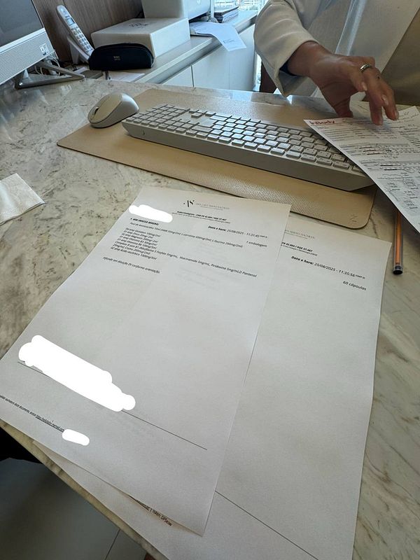 The image depicts a doctor's office setting with paperwork related to blood work and a computer setup.