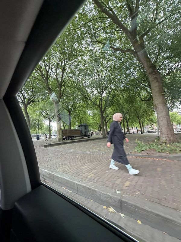 A map screenshot centering on Rotterdam with demographic change data points and navigation UI.