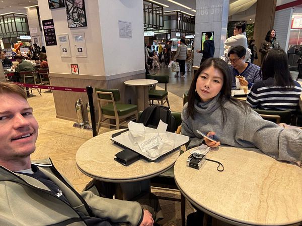 Bright yellow sandwich from Joe & The Juice on white bread with lettuce on a piece of parchment paper.
