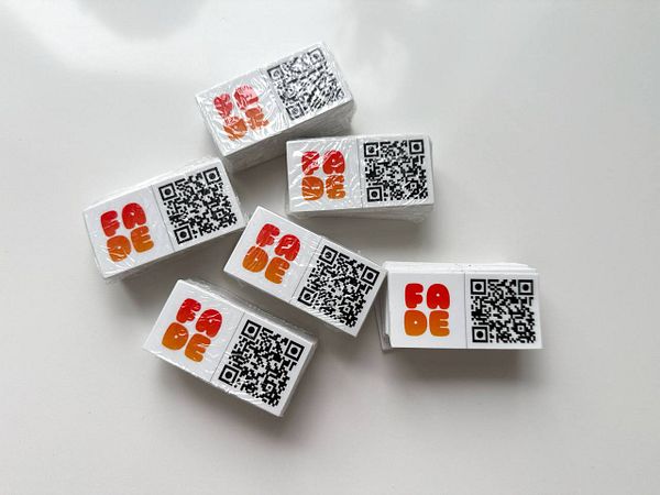 A collection of stickers featuring a new design and QR codes.