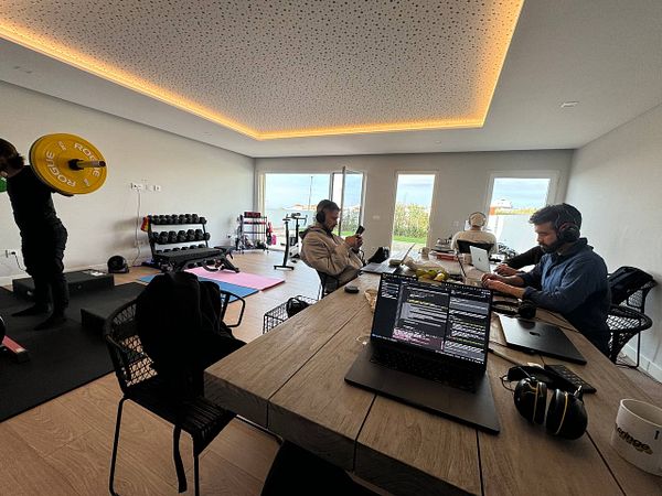 A coworking space featuring individuals engaged in work and fitness activities.