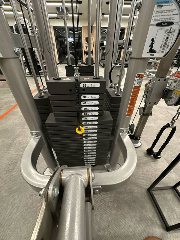 A close-up view of a gym weight machine's weight stack.