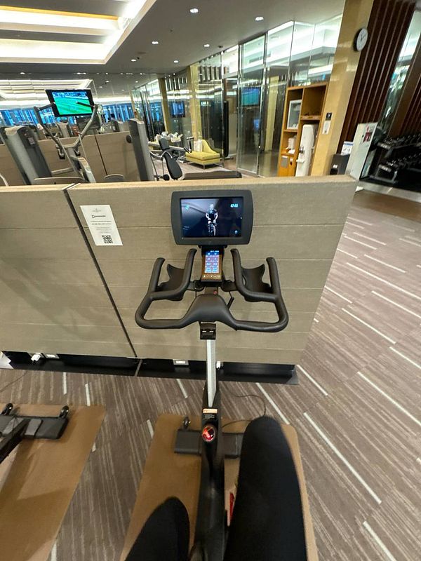 A view from a stationary bike in a modern gym setting in Osaka.