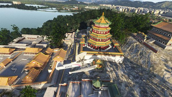 A seaplane flies over a scenic landscape featuring traditional Chinese architecture and a large body of water.