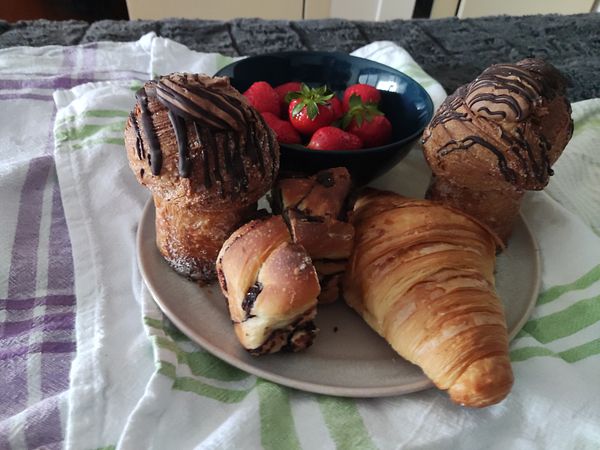 A cozy breakfast spread featuring pastries and strawberries.