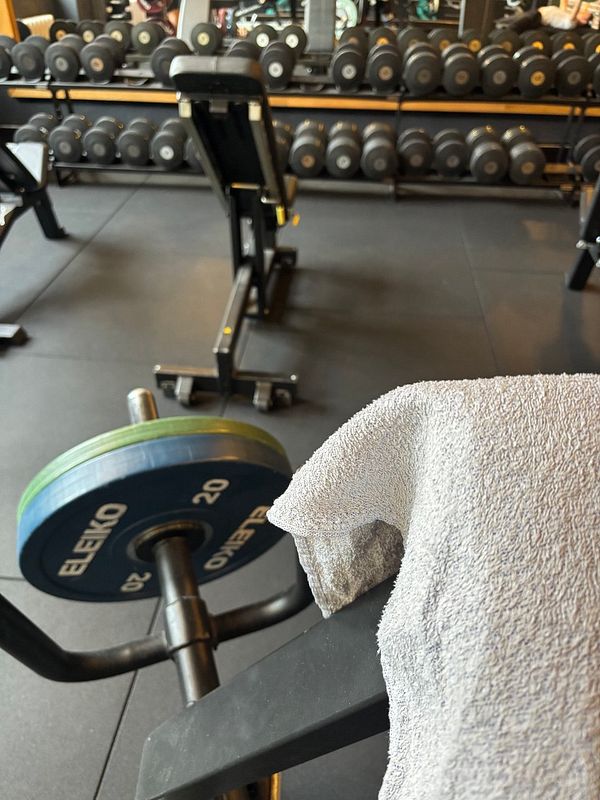 A gym setting featuring weights and workout equipment.