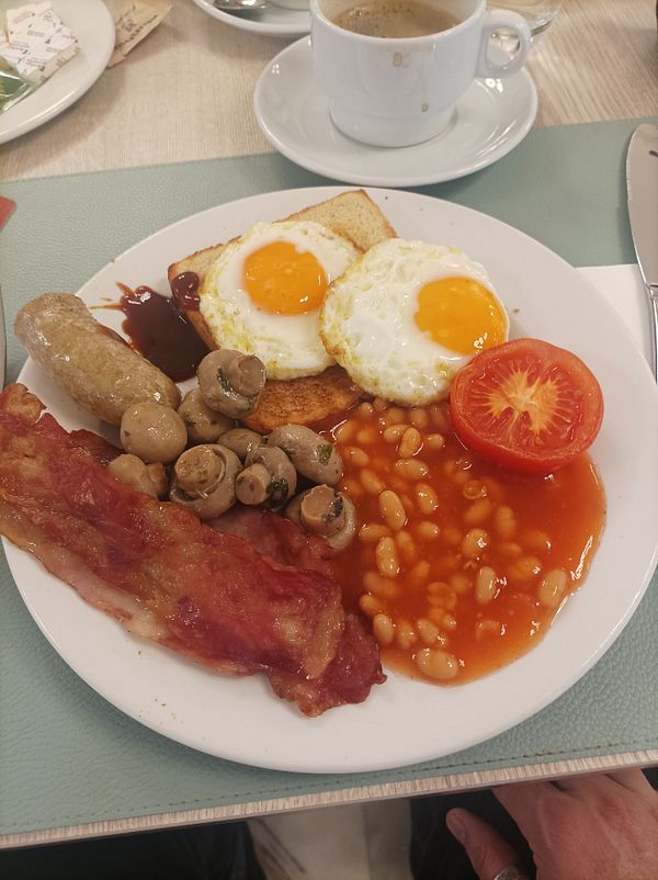 A hearty English breakfast served on a white plate.