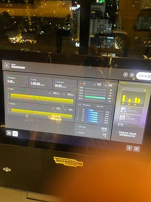 The image displays a workout summary on a Technogym treadmill screen.