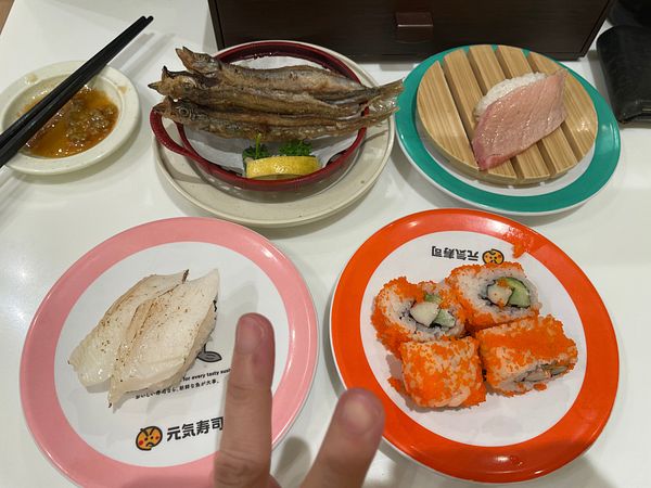 A colorful city scene with street life, a tram, and tall buildings under a vibrant blue and orange sky.