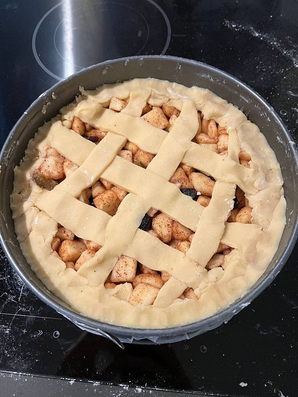 A freshly prepared apple pie ready for baking.