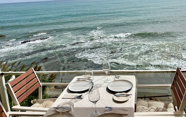 A scenic dining setup overlooking the ocean waves.