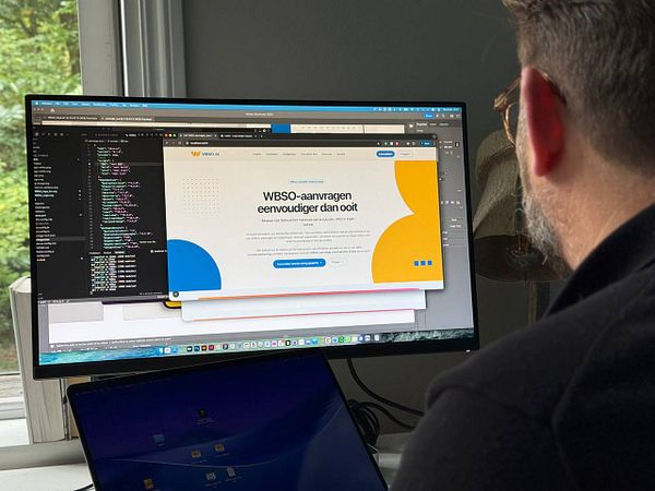 A person is working on a computer, focusing on a web design project for the WBSO homepage.