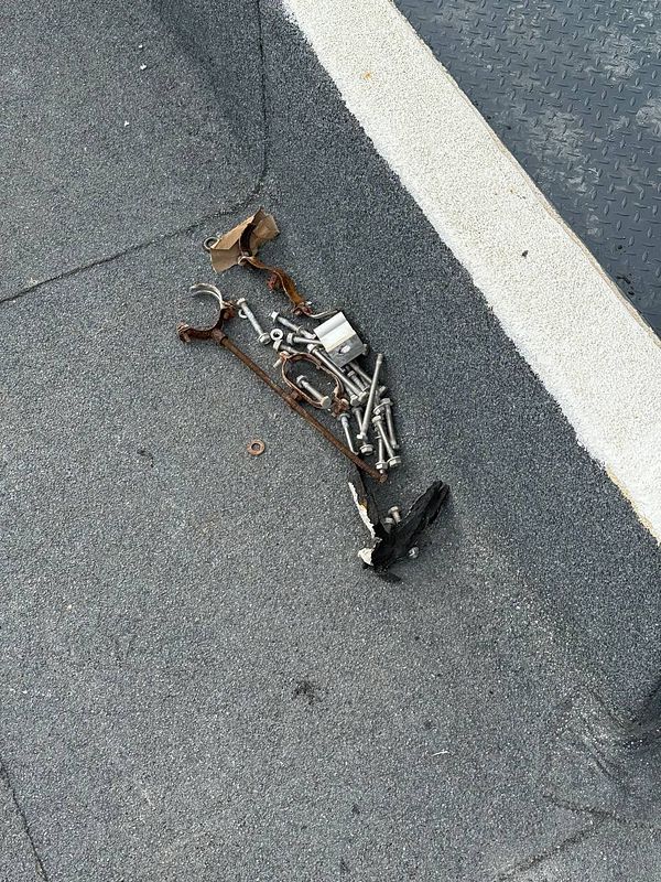 A collection of discarded materials and tools left on a roof after solar panel installation.