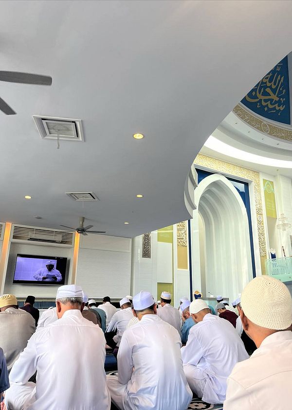 A group of worshippers attending Friday prayers in a mosque.