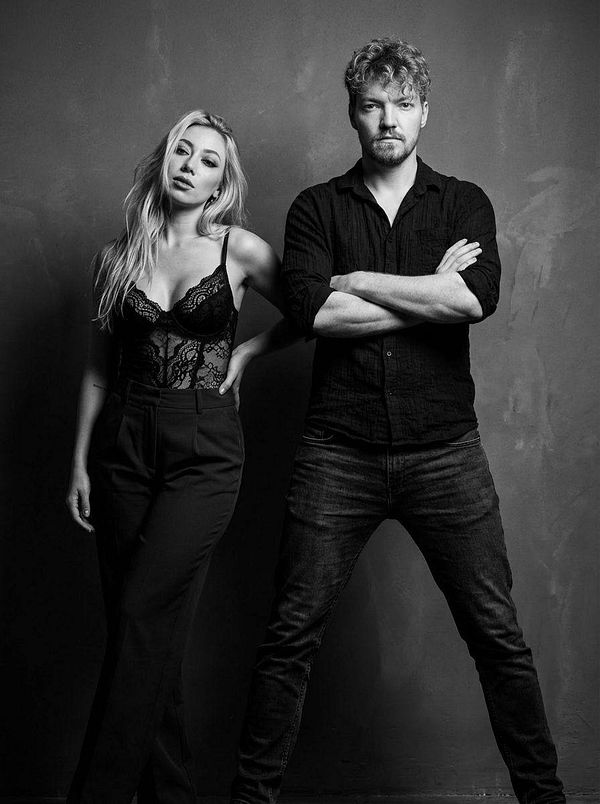 A black and white portrait of a man and a woman posing together.