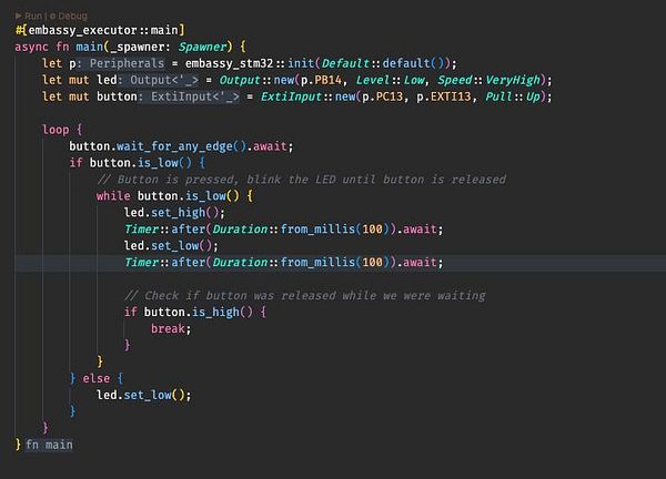 The image displays a code snippet written in Rust for controlling an LED based on a button press using the Embassy framework on an STM32 microcontroller.