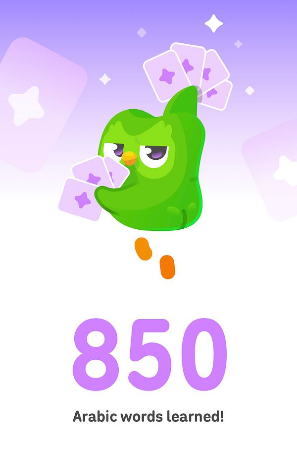 Duolingo owl celebrating learning 850 Arabic words with purple star cards and a purple background.